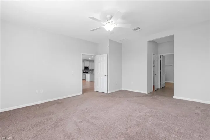 Master bedroom with carpet and ceiling fan