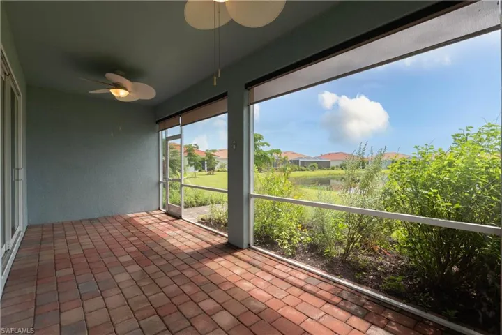 Unfurnished sunroom with ceiling fan