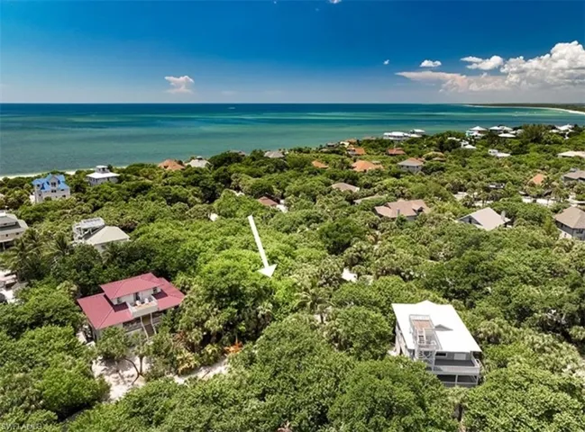Aerial view of residential area featuring a large body of water