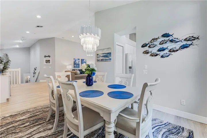 Dining area with an inviting chandelier and wood-type flooring