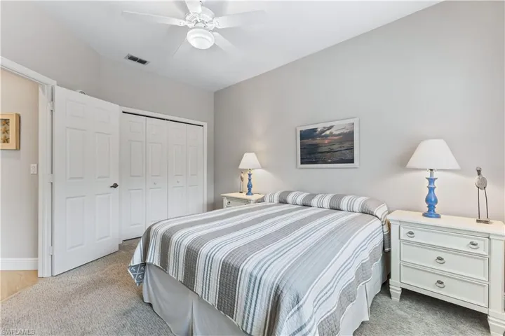 Carpeted bedroom with a closet and ceiling fan