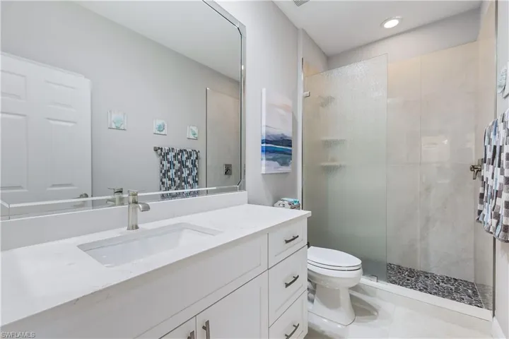 totally redone hall bath with step in shower and tile flooring