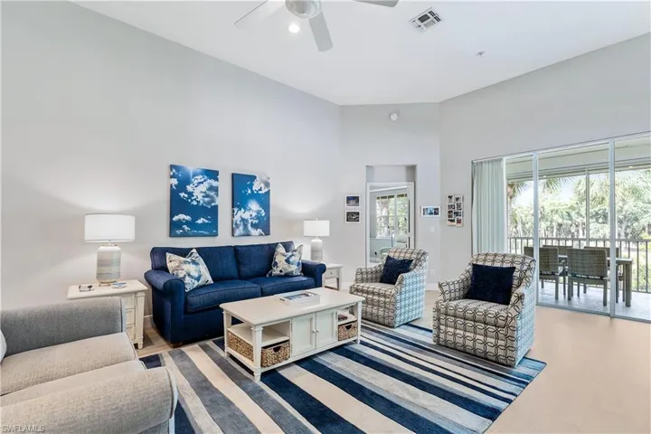 Living room with a high ceiling and ceiling fan