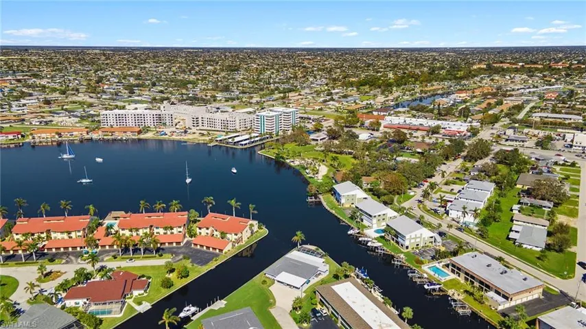 Birds eye view of property with a water view