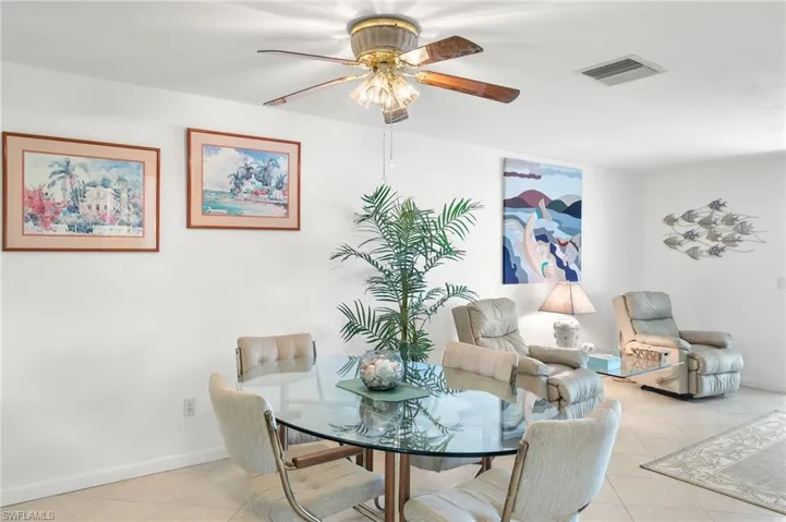 Tiled dining room featuring ceiling fan