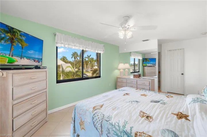 Tiled bedroom with ceiling fan