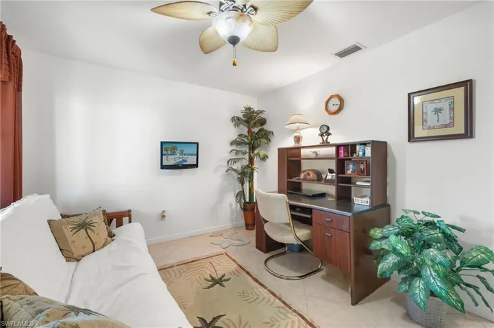 Office space with ceiling fan and light tile patterned floors
