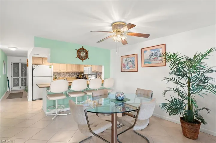 Dining room featuring ceiling fan and light tile patterned floors