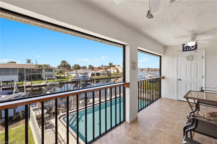 Balcony with a water view and ceiling fan