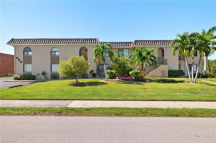 Mediterranean / spanish home with a front lawn