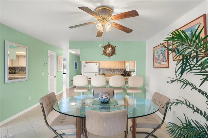 Dining space featuring light tile patterned floors and ceiling fan