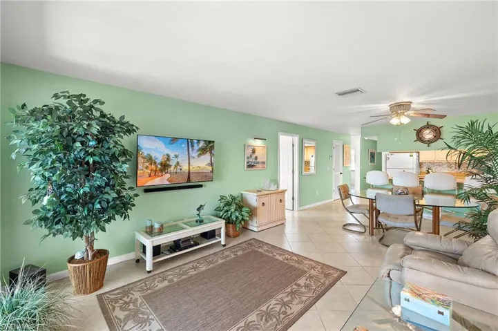 Tiled living room featuring ceiling fan