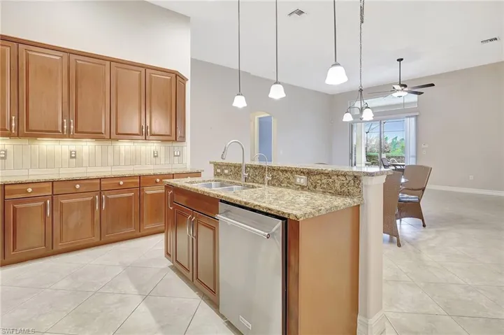 Large kitchen overlooking family room and glass sliding doors out to pool.