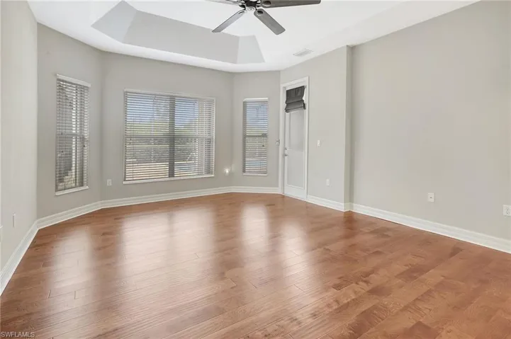 Another view of large primary bedroom with door leading out to pool/lanai