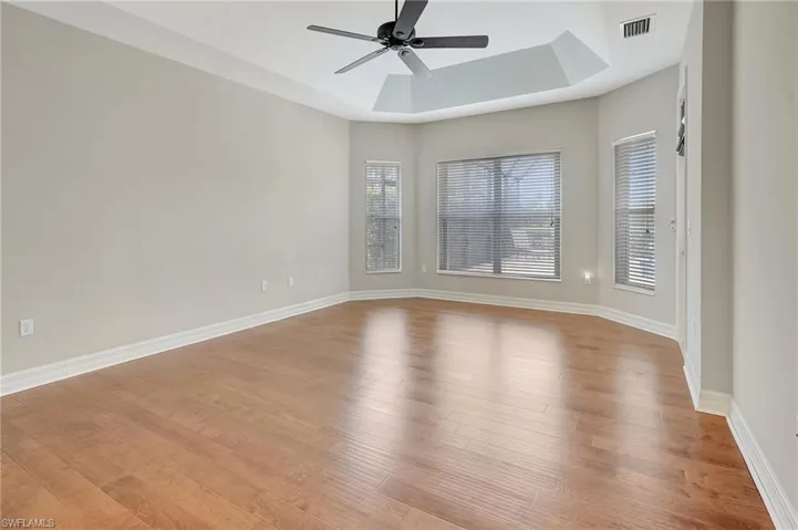 Wood Plank flooring, a tray ceiling, nook with view of pool