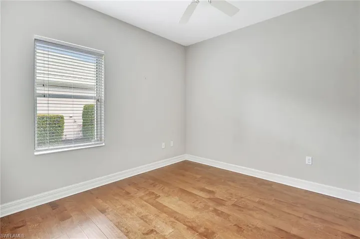 Unfurnished room featuring ceiling fan and hardwood / wood-style floors