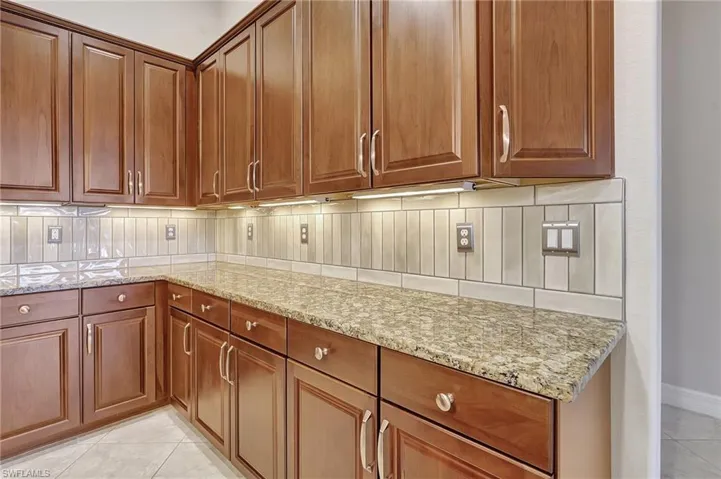Beautiful countertops, tile backsplash with under cabinet lighting
