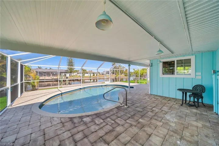 Outdoor pool with a lanai and a patio