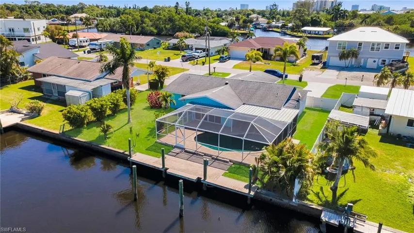 Drone / aerial view with a water view and a residential view