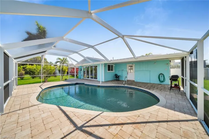 Pool with a lanai and a patio