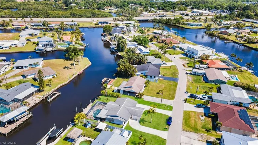 Birds eye view of property with a residential view and a water view