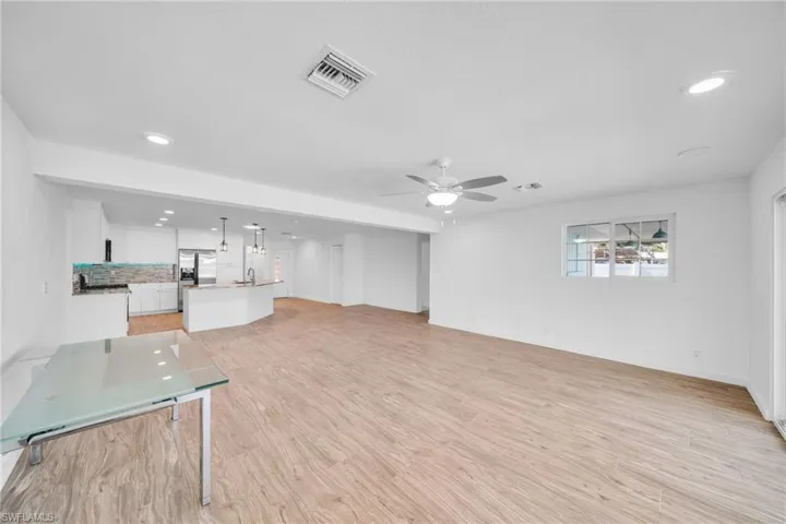 Unfurnished living room with visible vents, light wood-style flooring, recessed lighting, and a ceiling fan