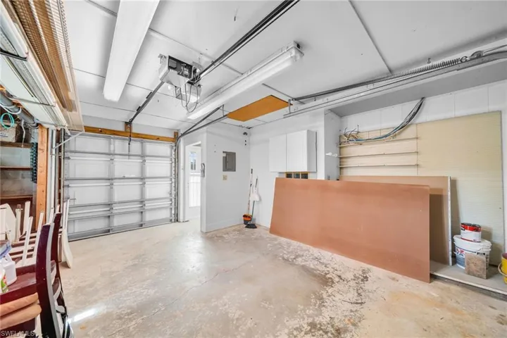 Garage with electric panel and a garage door opener