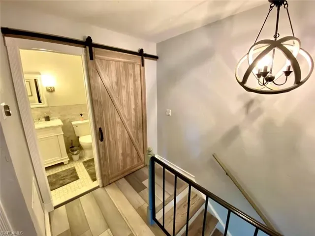 Stairway featuring wood finished floors