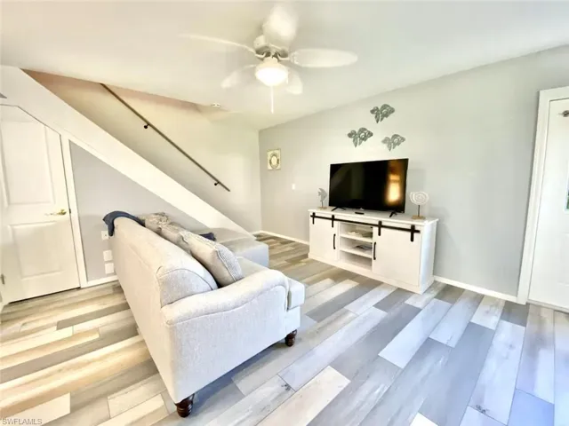 Living area featuring light wood finished floors and ceiling fan