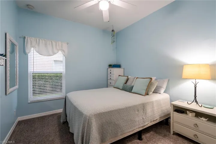 Bedroom featuring dark colored carpet and ceiling fan