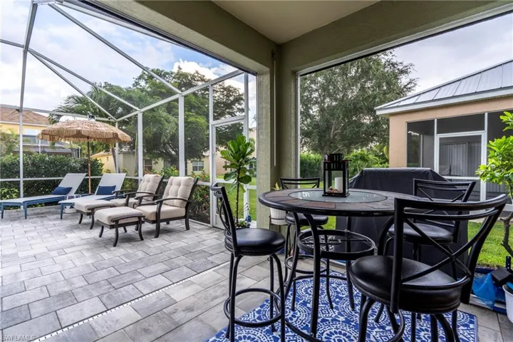 Sunroom with outdoor dining area and a patio area