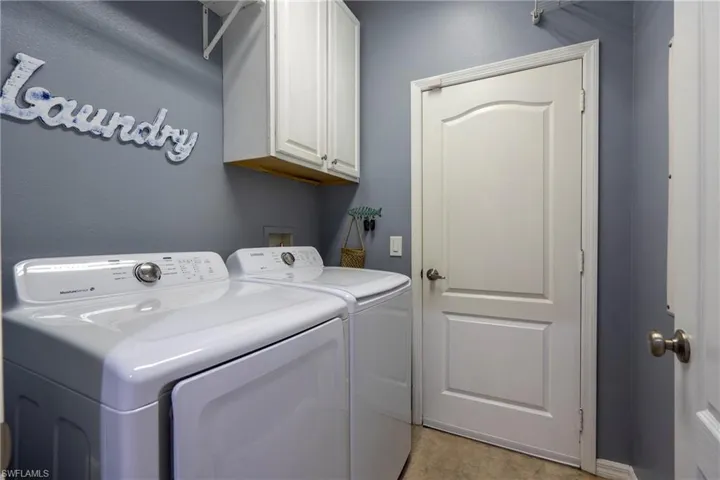 Laundry room with cabinet space and washing machine and dryer