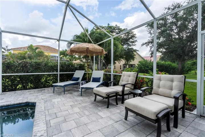 View of patio / terrace with a sunroom, a lanai, and an outdoor pool