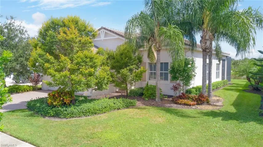 View of property exterior with a yard and stucco siding