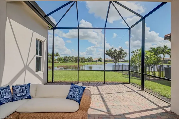 Sunroom featuring a patio area and a water view