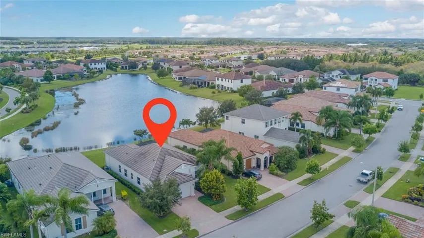 Aerial perspective of suburban area with a nearby body of water