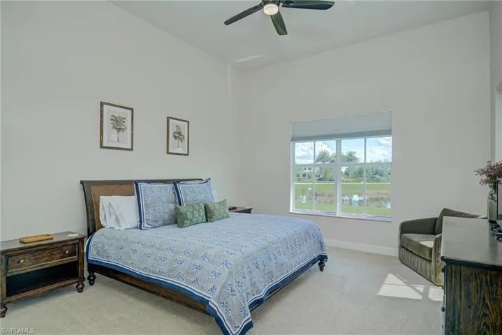 Carpeted bedroom featuring baseboards and a ceiling fan