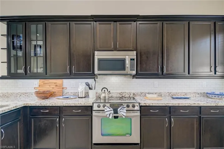 Kitchen featuring stainless steel appliances and dark brown cabinets
