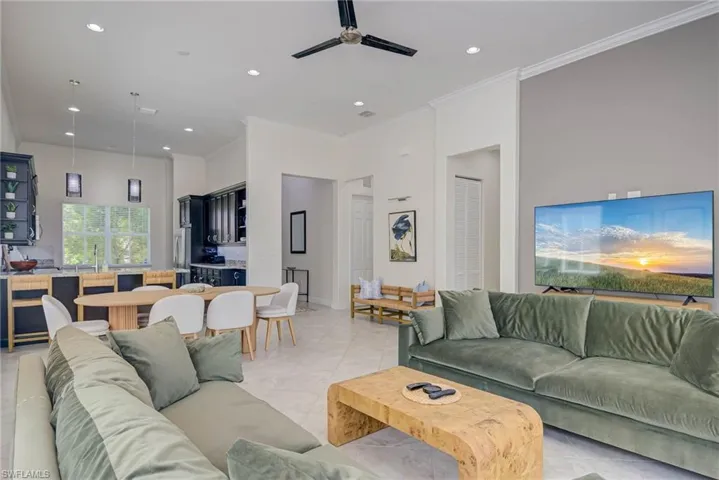 Living room featuring crown molding, recessed lighting, and a ceiling fan