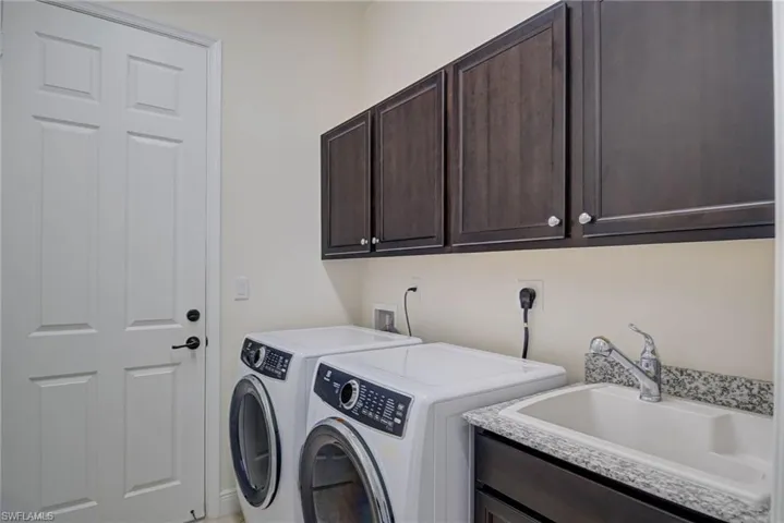 Laundry room with cabinet space and washing machine and clothes dryer