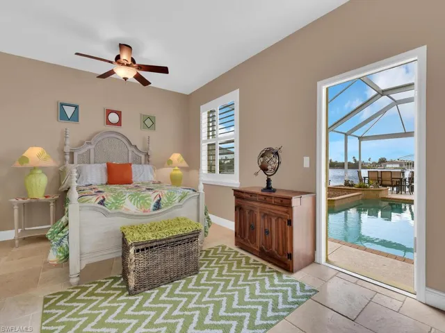 Bedroom with access to exterior and ceiling fan
