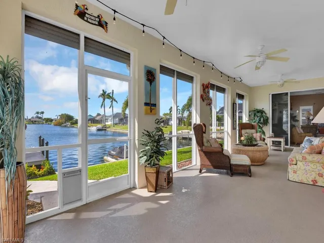 Sunroom with a water view and ceiling fan