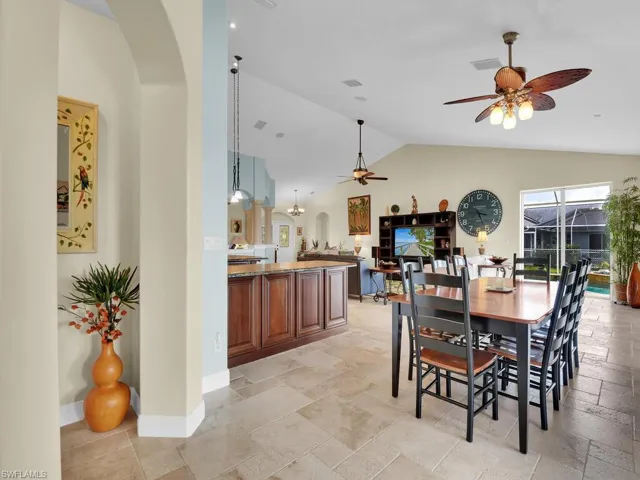 Dining room with lofted ceiling and ceiling fan