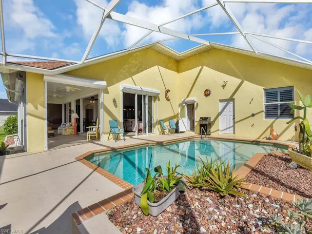 Back of house with a patio area and a lanai
