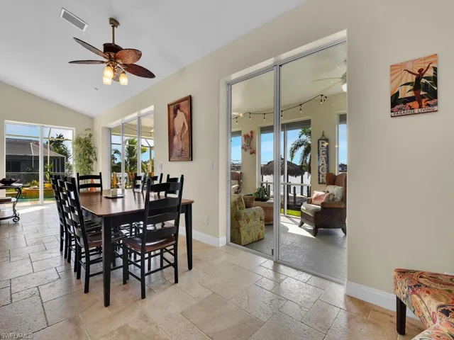 Dining room with lofted ceiling and ceiling fan
