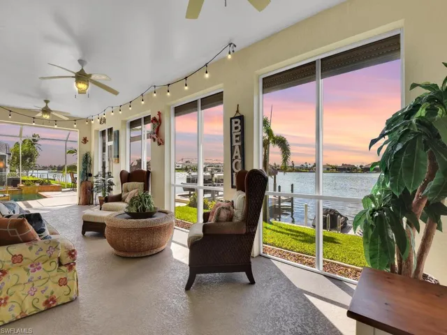 Sunroom featuring a water view and ceiling fan