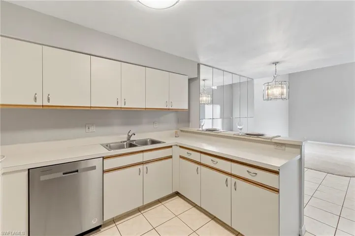 Bright open kitchen, beautiful new lighting in dining area.