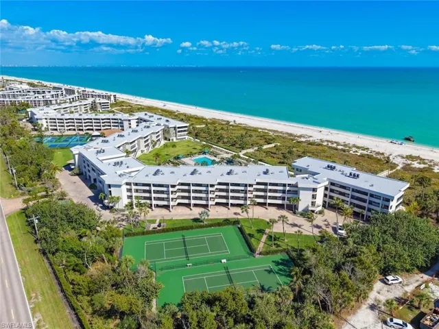 Aerial view of unending shoreline and apartment complex