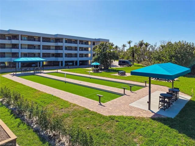View of property's community with a bocce ball area and a patio area