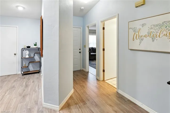 Hallway with baseboards and light wood-type flooring